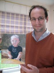 Picture of Michael with his painting of his toddler after art lessons with jeanni