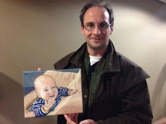 Picture of Michael with his painting of his baby after art lessons with jeanni
