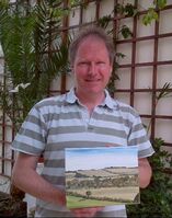 Picture of a gentleman with his painting after completing the third art lesson with jeanni
