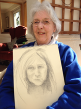 Picture of a lady with her sketch of jeanni after her first lesson at the Nare Hotel
