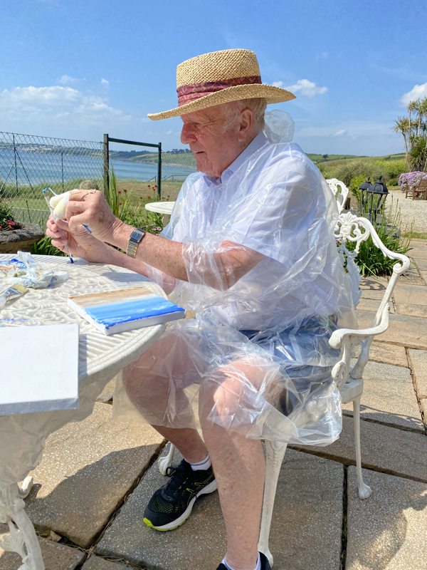 A gentleman painting with jeanni at the Nare Hotel. Jeanni is the hotels - artist in residence