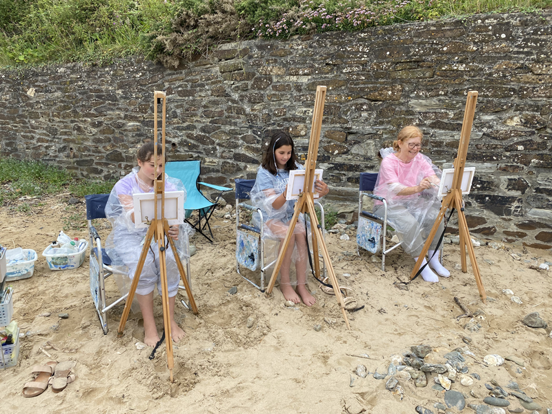 3 young ladies painting on the beach with jeanni