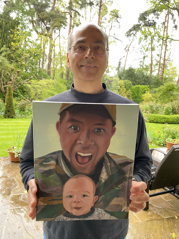 Picture of a proud gentleman with his painting of his new grandson  